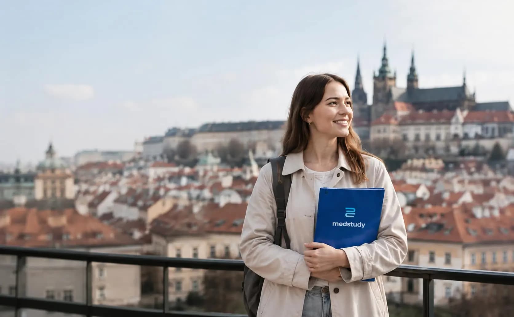 Medstudy student with a folder in front of a Prague background